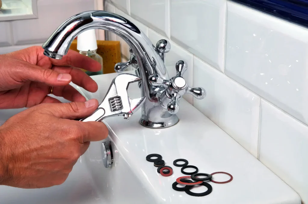 Plumber performing maintenance on a bathroom faucet in Altamonte Springs