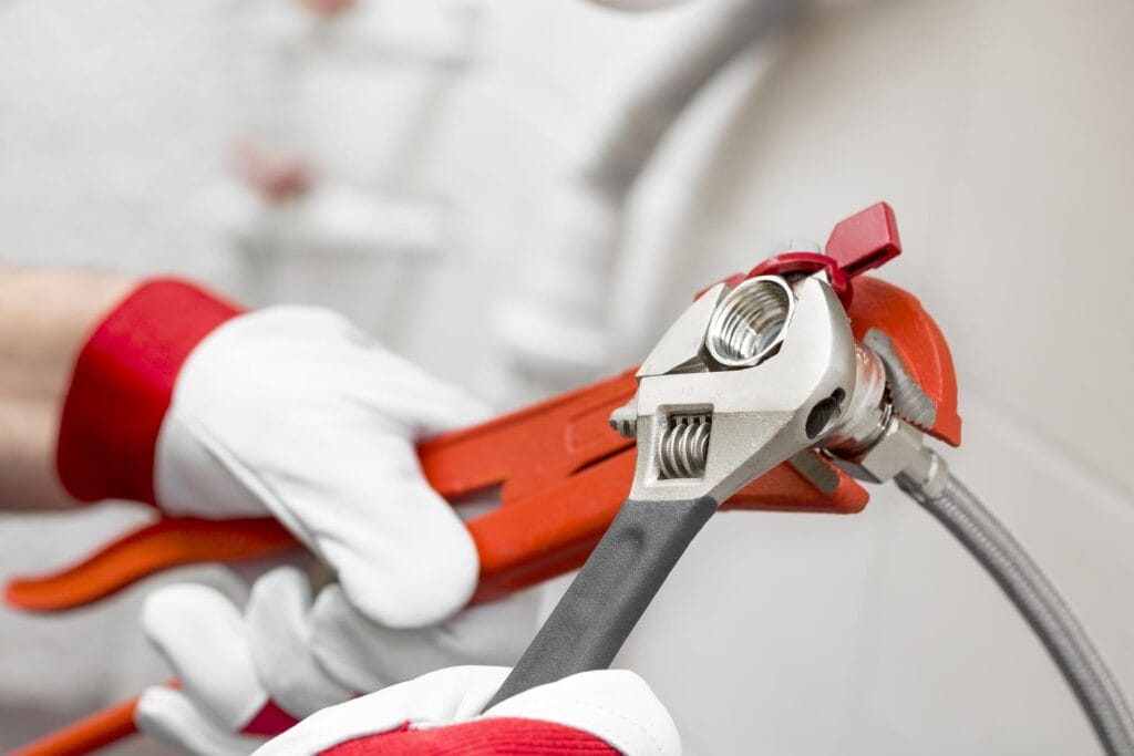 Plumber holding pipe wrenches for an emergency repair in Altamonte Springs