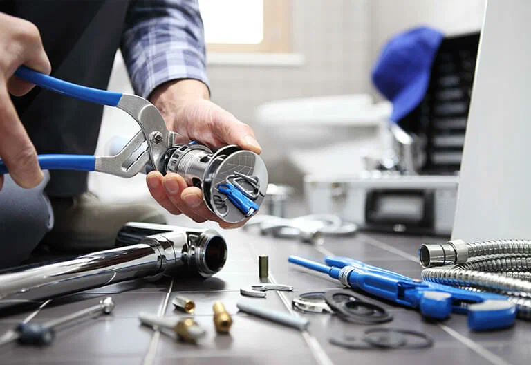 Technician repairing a plumbing fixture with professional tools in Altamonte Springs