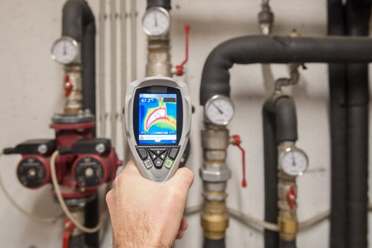 Plumber using a thermal imaging camera to inspect pipes in Altamonte Springs