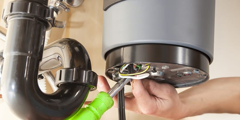 Technician repairing the heating element of a water heater in Altamonte Springs