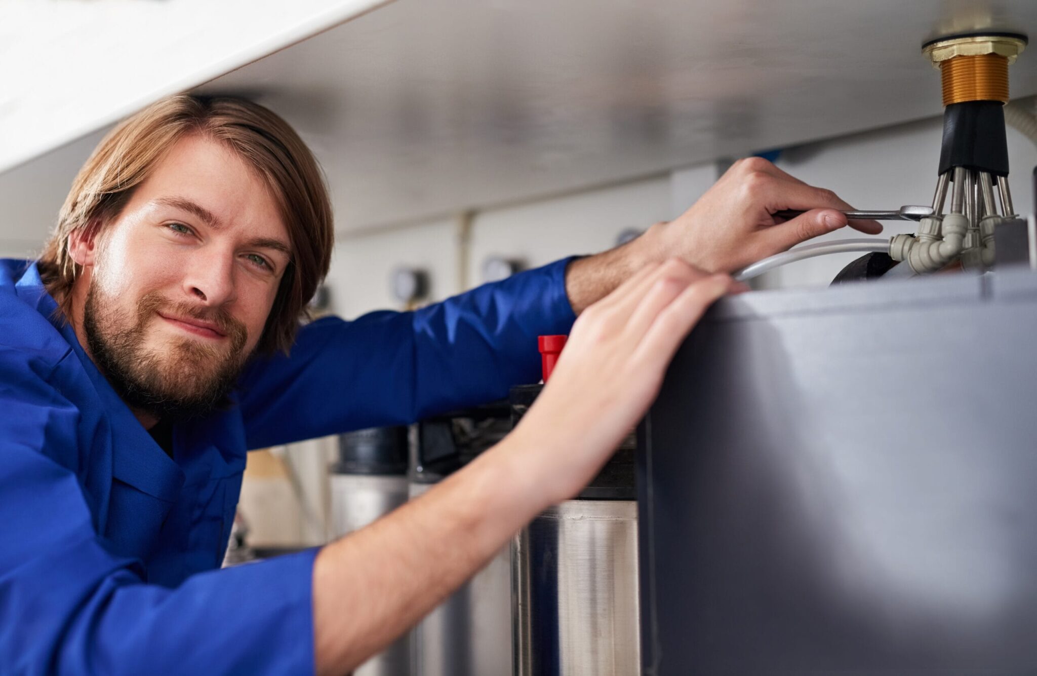Technician servicing a residential water heater tank in Altamonte Springs
